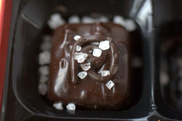 Close-up of a Trader Joe's Dark Chocolate Sea Salt Caramel topped with salt crystals