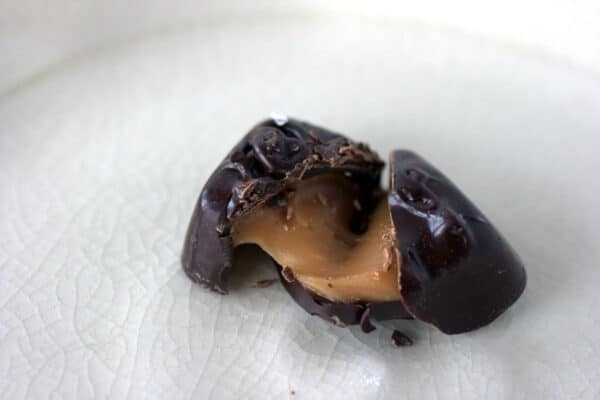 Trader Joe's Dark Chocolate Sea Salt Caramel cut in half showing the caramel center