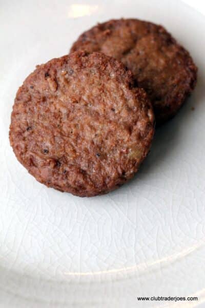 Two cooked Trader Joe's Veggie Sausage Patties on a white plate